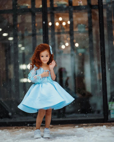 toddler girl twirling in a blue dress